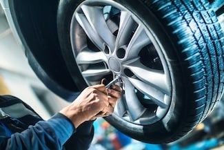 image of a person servicing a tire